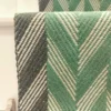 Green Herringbone stair runner with dark green woven border on white stairs