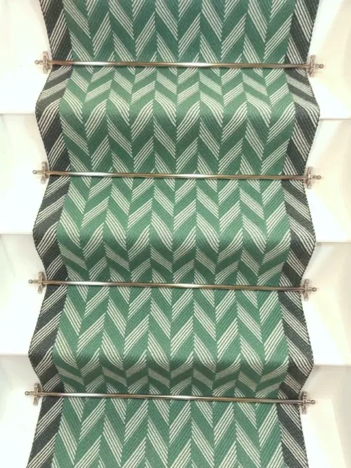 Green Herringbone stair runner with dark green woven border on white stairs