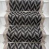Black and white Herringbone Stair Runner with a grey woven border on white stairs