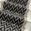 Black and white Herringbone Stair Runner with a grey woven border on white stairs