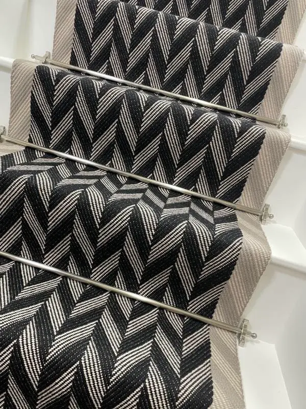 Black and white Herringbone Stair Runner with a grey woven border on white stairs