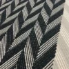 Black and white Herringbone Stair Runner with a grey woven border on white stairs