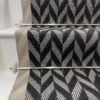 Black and white Herringbone Stair Runner with a grey woven border on white stairs