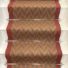 Cinnamon and Spruce Herringbone stair runner with vibrant red woven border on white stairs
