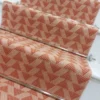 Light pink stair runner with triangle pattern on white wooden stairs